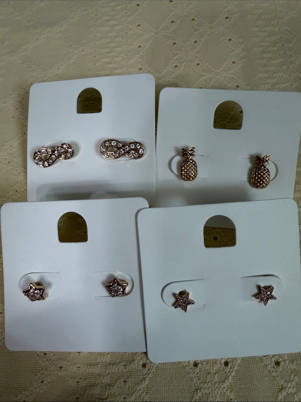 Four pairs of dainty gold tone earring studs